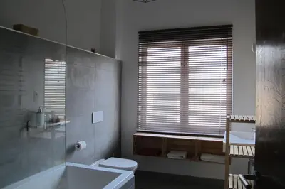 a bathroom with a tub and a toilet and a sink at Brussels Downtown in Brussels