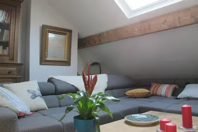 a living room with a blue couch and a table at Brussels Downtown in Brussels