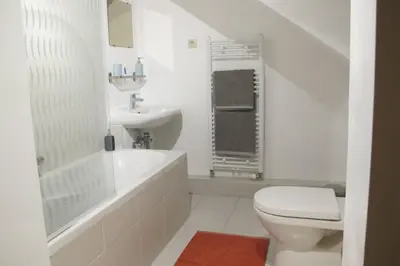 a white bathroom with a toilet and a sink at Brussels Downtown in Brussels