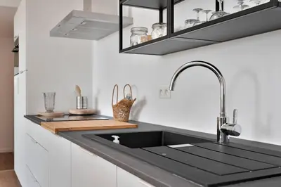 a kitchen with a black sink and a counter at City PENTHOUSE, rooftop terrace, free NETFLIX, wifi and airco in Antwerp