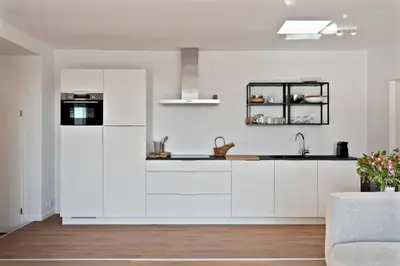 a kitchen with white cabinets and a white refrigerator at City PENTHOUSE, rooftop terrace, free NETFLIX, wifi and airco in Antwerp