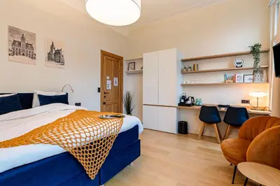 a bedroom with a bed and a table and chairs at Borgerhouse B&B in Antwerp
