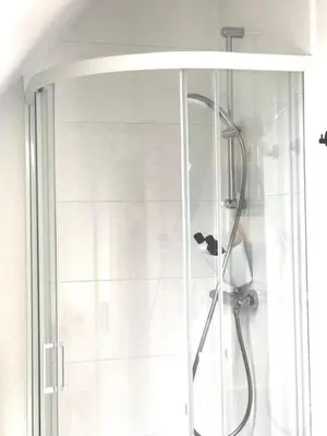 a shower with a glass door in a bathroom at Boslucht Leuven in Heverlee