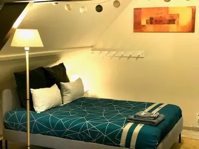 a bedroom with a bed and a lamp in it at Boslucht Leuven in Heverlee