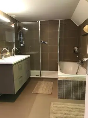 a bathroom with a shower and a sink and a tub at Boslucht Leuven in Heverlee