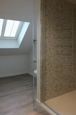 a bathroom with a sliding glass door with a toilet at De Kaai in Halle