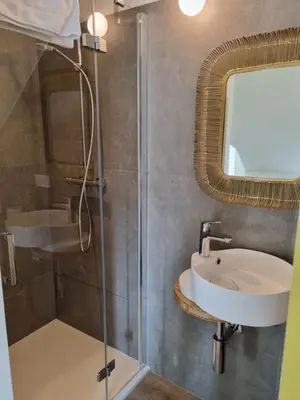 a bathroom with a sink and a shower at De Kaai in Halle