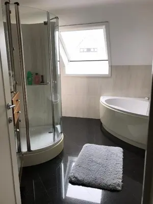 a bathroom with a shower and a tub and a sink at Hazegewoud in Arendonk