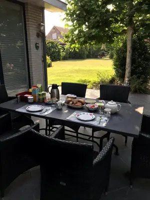 a table with a plate of food on it at Hazegewoud in Arendonk