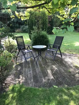 two chairs and a table in a yard at Hazegewoud in Arendonk