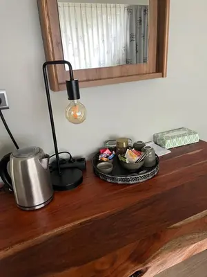 a table with a tea pot and a lamp on it at Hazegewoud in Arendonk