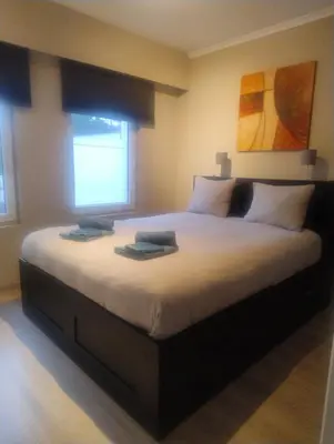 a bedroom with a large bed with two books on it at AmberHuis in Kasterlee