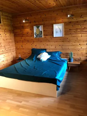 a bedroom with a bed in a wooden wall at Op den Heust in Arendonk