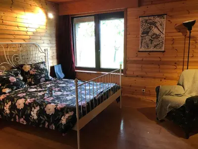 a bedroom with a bed in a log cabin at Op den Heust in Arendonk