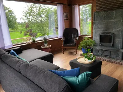 a living room with a couch and a fireplace at Op den Heust in Arendonk