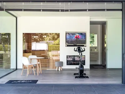 a room with a tv and a table with a camera at B&B Welness Sport and Pleasure in Laarne