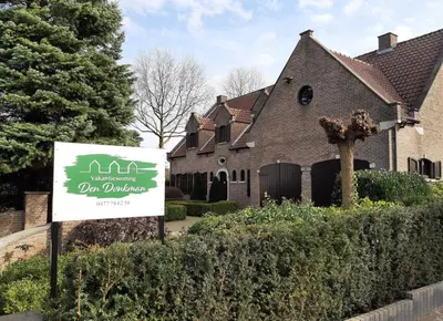 a sign in front of a house with a yard at Den Donkman in Dessel