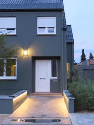 a house with a white door on the side of it at Kitrino in Geel