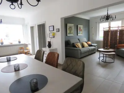 a living room with a table and a couch at Kitrino in Geel