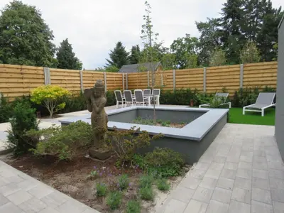 a garden with a statue in the middle at Kitrino in Geel