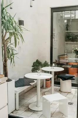 two tables and two chairs in a room at The 1880 Boutique Holiday Home in Antwerp