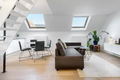 a living room with a couch and a table at The 1880 Residence by Domani Hotels in Antwerp