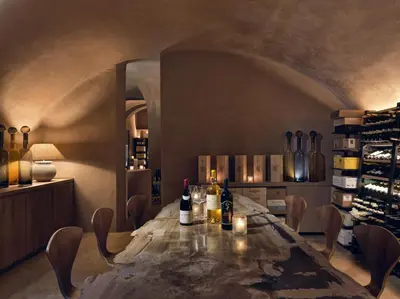 a dining room with a table with bottles of wine at Botanic Sanctuary Antwerp - The Leading Hotels of the World in Antwerp