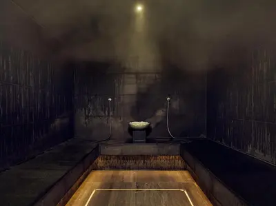 a dark bathroom with a toilet and a sink at Botanic Sanctuary Antwerp - The Leading Hotels of the World in Antwerp
