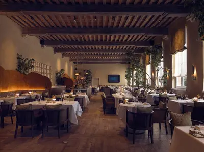 a dining room with white tables and chairs at Botanic Sanctuary Antwerp - The Leading Hotels of the World in Antwerp