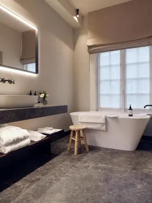 a bathroom with a tub and a sink and a window at Botanic Sanctuary Antwerp - The Leading Hotels of the World in Antwerp