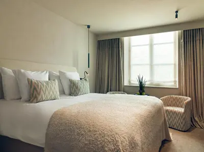a hotel room with a large bed and a window at Botanic Sanctuary Antwerp - The Leading Hotels of the World in Antwerp