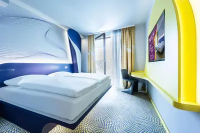 a hotel room with a bed and a window at Prize by Radisson, Antwerp City in Antwerp