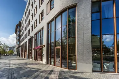 a building with large glass windows on a street at Prize by Radisson, Antwerp City in Antwerp