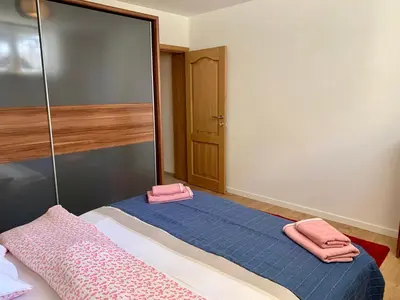 a bedroom with a bed with pink towels on it at Appartement Chez Agnes in Brussels