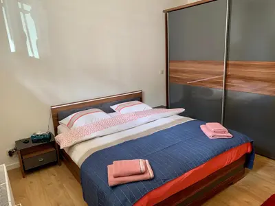 a bedroom with a bed with pink towels on it at Appartement Chez Agnes in Brussels