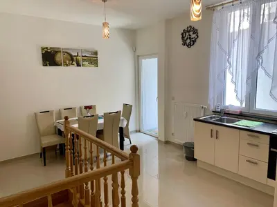 a kitchen and dining room with a table and chairs at Appartement Chez Agnes in Brussels