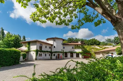 an exterior view of a house with a courtyard at La Hacienda in Vilvoorde