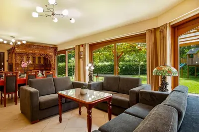 a living room with a couch and a table at La Hacienda in Vilvoorde