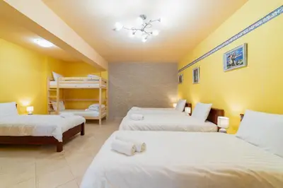 a room with three beds and bunk beds at La Hacienda in Vilvoorde