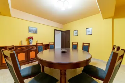 a dining room with a wooden table and chairs at La Hacienda in Vilvoorde