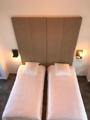 two beds in a room with two pillows at Brussel House Basilic in Brussels