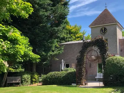 an old brick church with a clock tower at T klein Kasteeltje Wetteren in Wetteren