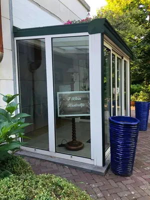 a screened in house with a television in it at T klein Kasteeltje Wetteren in Wetteren