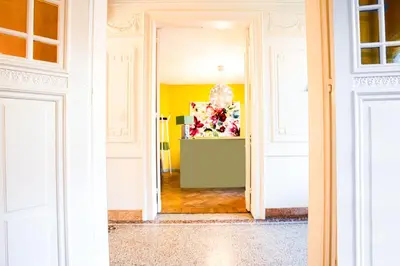 a hallway with a door open to a room with yellow at Villa Tilia in Retie