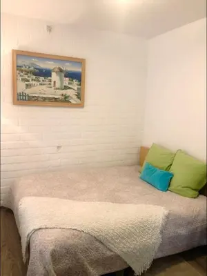 a bed in a room with a picture on the wall at Residence Lilac in Brussels
