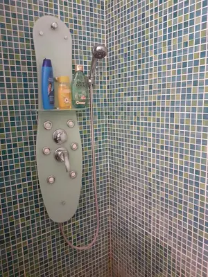a shower in a bathroom with a tiled wall at Residence Lilac in Brussels