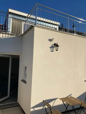a building with two chairs and a balcony at Dreamland Apartments EU, Brussels in Brussels