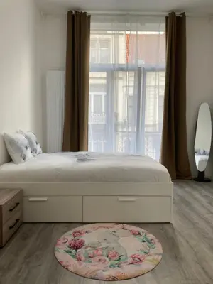 a bedroom with a large bed with a large window at Dreamland Apartments EU, Brussels in Brussels