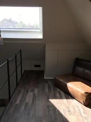 a living room with a couch and a window at B&B Sint-Mariaburg in Antwerp