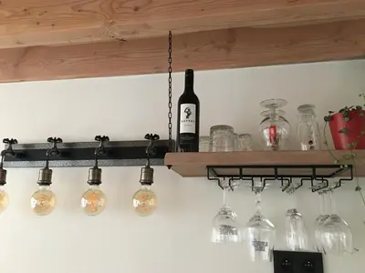a bunch of wine glasses hanging from a shelf at B&B Sint-Mariaburg in Antwerp